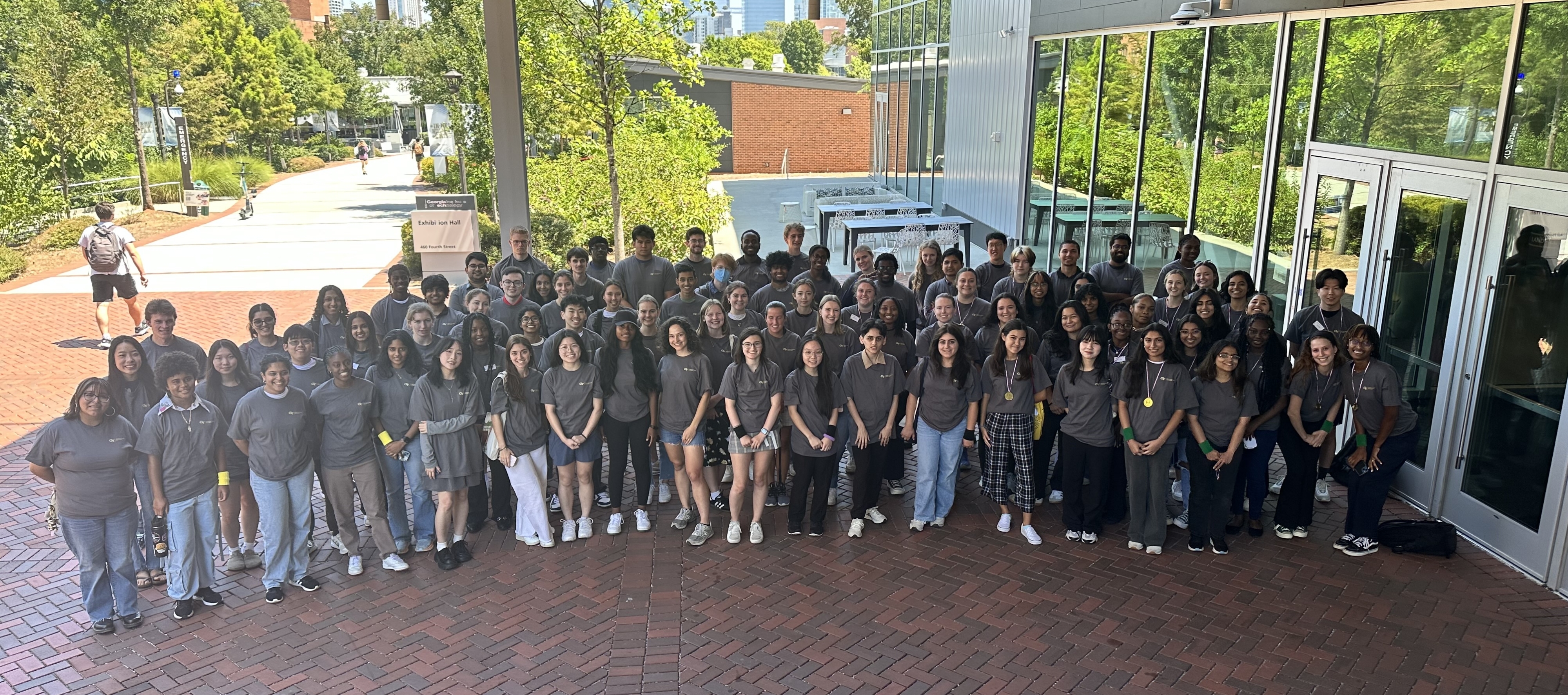 Large group of student employees wearing grey shirts